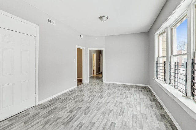 unfurnished room with light wood-type flooring