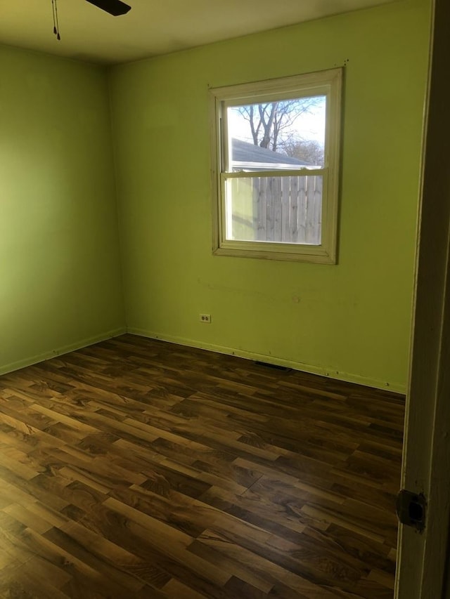 unfurnished room featuring ceiling fan and dark hardwood / wood-style floors