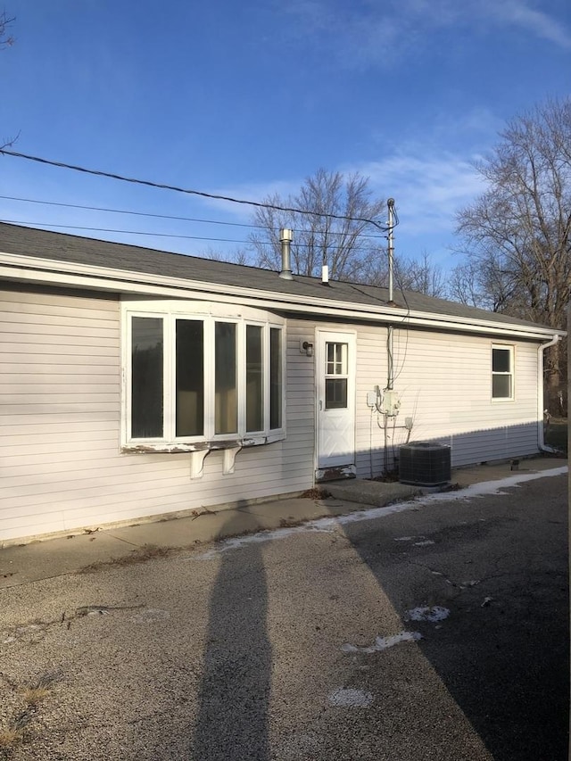 rear view of house with central air condition unit