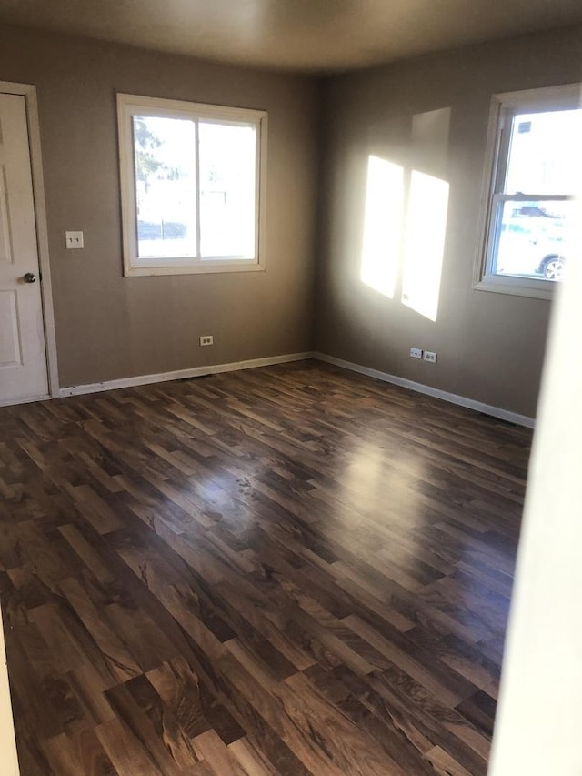 unfurnished room featuring dark hardwood / wood-style flooring