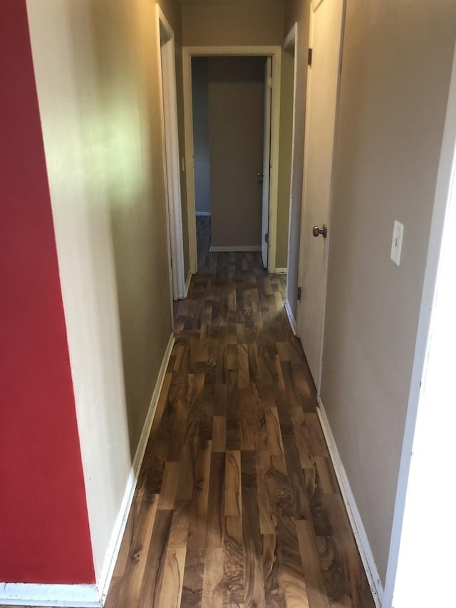 corridor featuring dark hardwood / wood-style floors