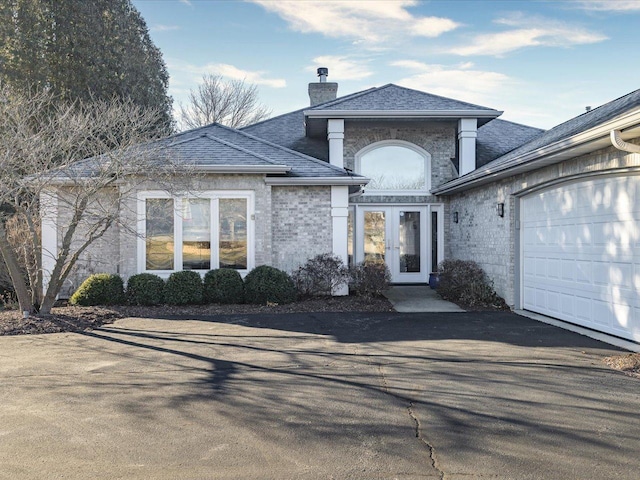 view of front of property with french doors and a garage