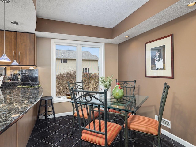 dining room featuring a textured ceiling