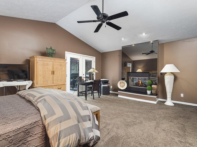 bedroom featuring a textured ceiling, vaulted ceiling, carpet, french doors, and ceiling fan