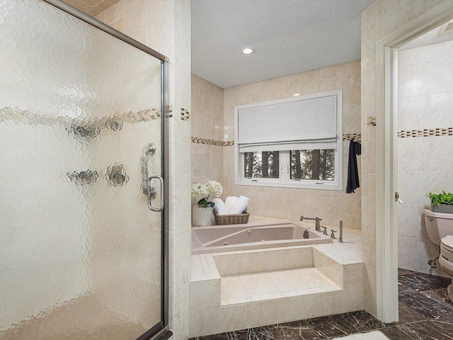 bathroom with tile walls, toilet, a textured ceiling, and plus walk in shower