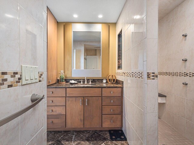 223 Lake Summerset Rd, Davis, IL 61019 - bathroom with marble look tile flooring, walk in shower, tile walls, vanity, and recessed lighting