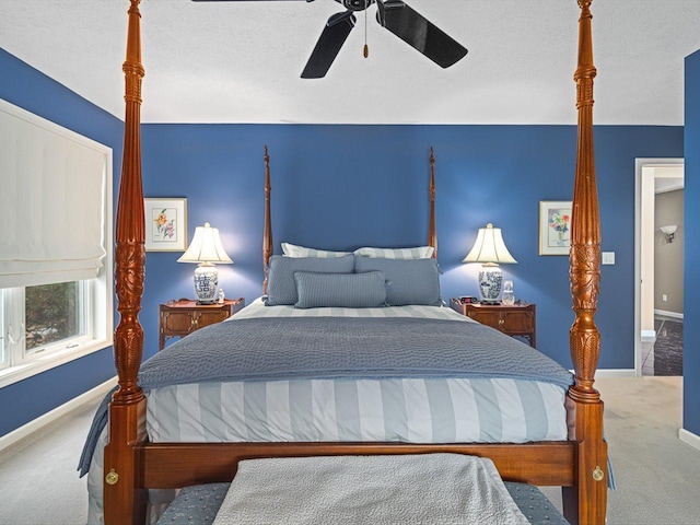 carpeted bedroom with a textured ceiling and ceiling fan