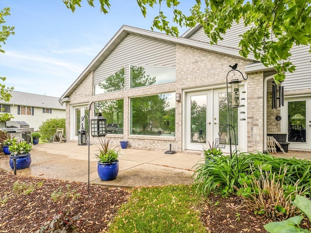223 Lake Summerset Rd, Davis, IL 61019 - back of property featuring french doors, a patio area, and brick siding