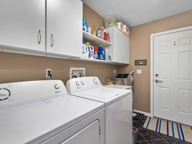 washroom with separate washer and dryer, cabinets, sink, and a textured ceiling