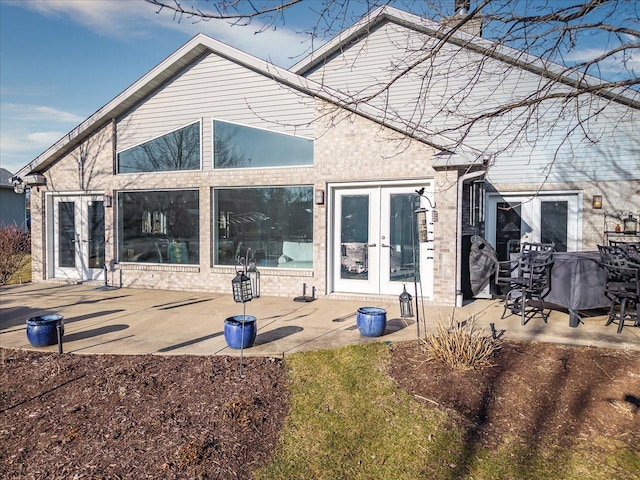 rear view of property with french doors and a patio