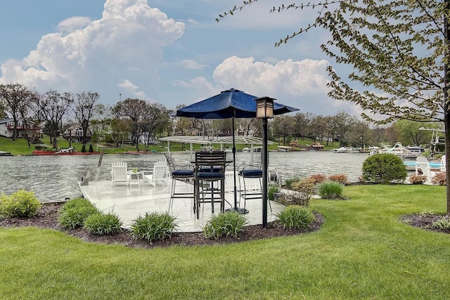 dock area featuring a lawn and a water view