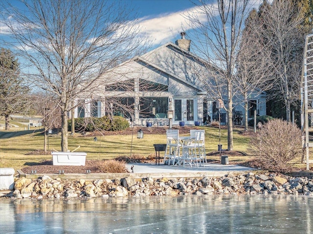 surrounding community with a yard, a water view, and a patio area