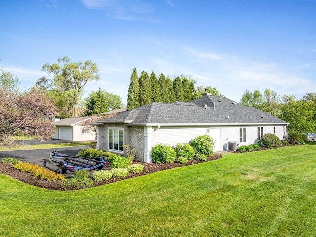 223 Lake Summerset Rd, Davis, IL 61019 - rear view of property with central AC and a yard