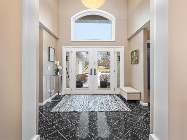 entryway with a high ceiling and french doors