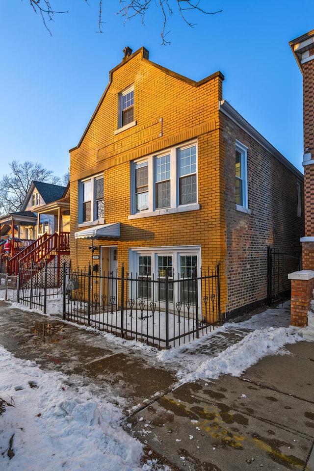 view of snow covered rear of property