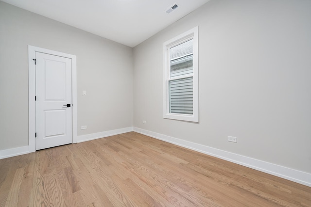 empty room with light hardwood / wood-style floors