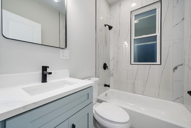 full bathroom with toilet, vanity, and tiled shower / bath