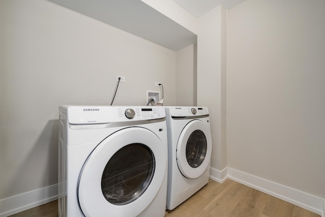 laundry area featuring light hardwood / wood-style floors and independent washer and dryer