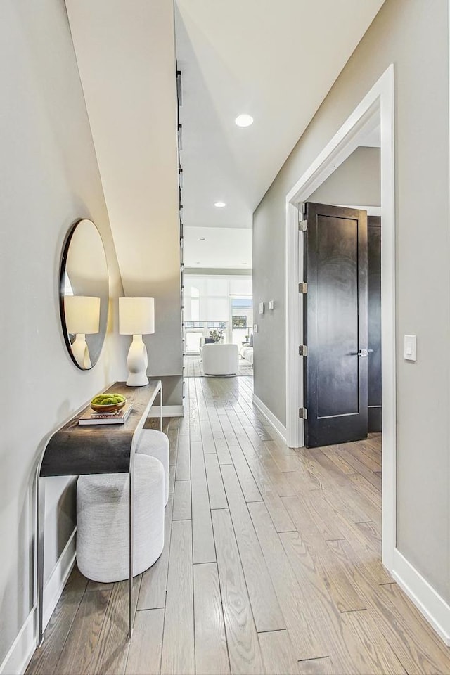 hallway with light hardwood / wood-style flooring