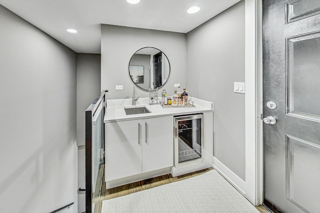 bathroom featuring beverage cooler, vanity, and hardwood / wood-style flooring