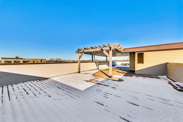 snow covered patio with a pergola