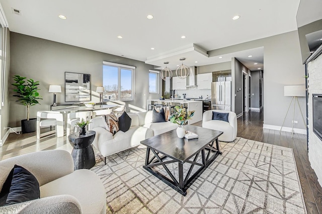 living room featuring light hardwood / wood-style flooring and a fireplace