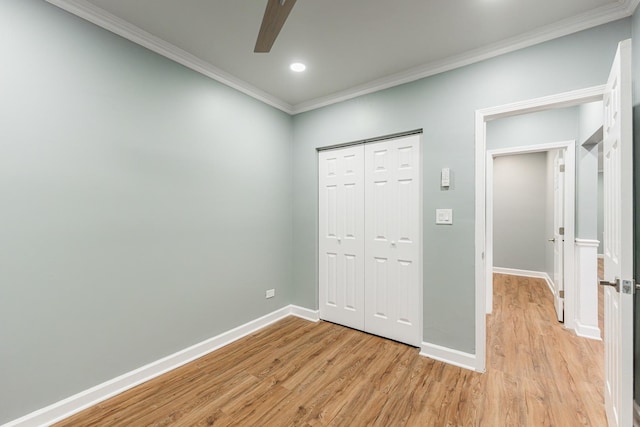 unfurnished bedroom featuring ornamental molding, a closet, ceiling fan, and light hardwood / wood-style floors