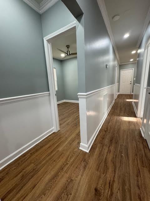 corridor with crown molding and dark hardwood / wood-style flooring