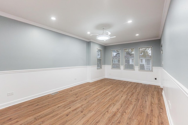 unfurnished room featuring ceiling fan, crown molding, and light hardwood / wood-style flooring