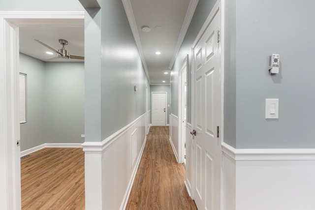 corridor with crown molding and wood-type flooring