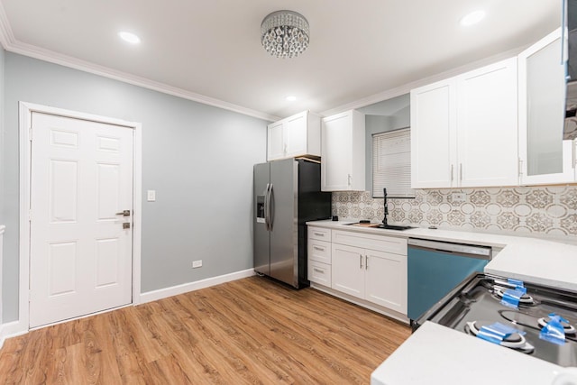 kitchen featuring white cabinetry, dishwasher, sink, stainless steel refrigerator with ice dispenser, and decorative backsplash