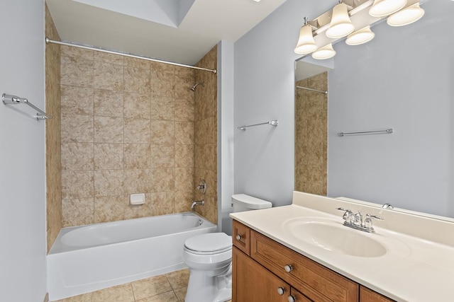 full bathroom featuring vanity, tile patterned floors, toilet, and tiled shower / bath