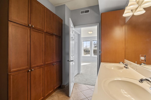 bathroom with tile patterned floors and vanity