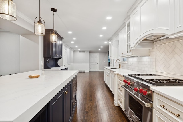 kitchen with stainless steel range, dark wood-style floors, crown molding, backsplash, and recessed lighting