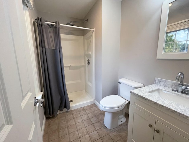 bathroom with toilet, a shower stall, and vanity