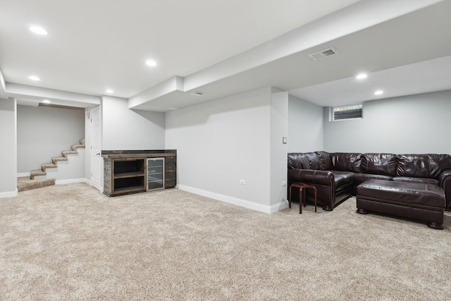 living area featuring visible vents, baseboards, carpet, stairs, and recessed lighting