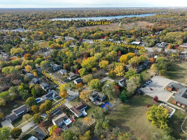 drone / aerial view with a water view and a view of trees