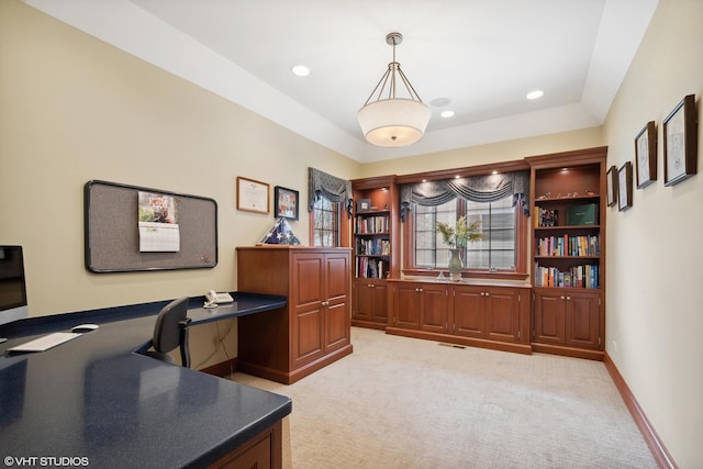 carpeted home office featuring built in desk