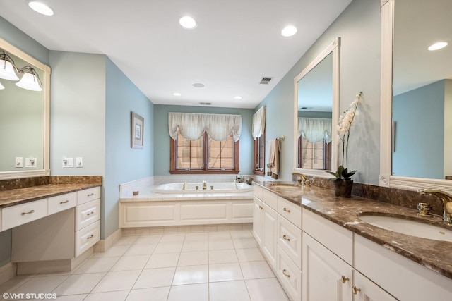 bathroom featuring vanity, tile patterned floors, and a bath