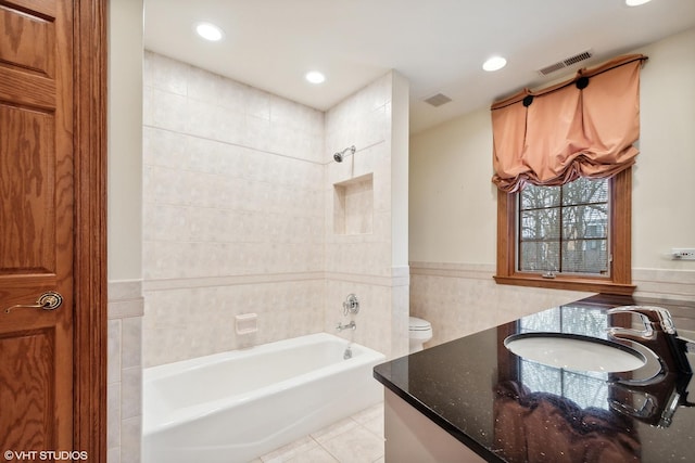 full bathroom with toilet, plus walk in shower, tile patterned floors, vanity, and tile walls