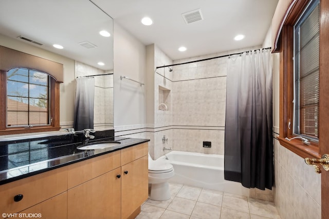 full bathroom with toilet, vanity, tile patterned floors, and shower / bath combo with shower curtain