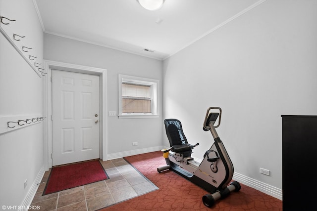 workout room featuring crown molding