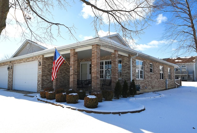 view of snowy exterior with a garage