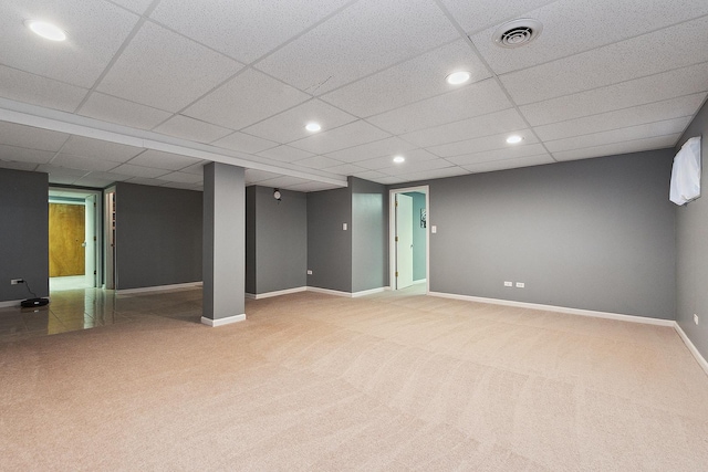 basement featuring carpet flooring and a drop ceiling