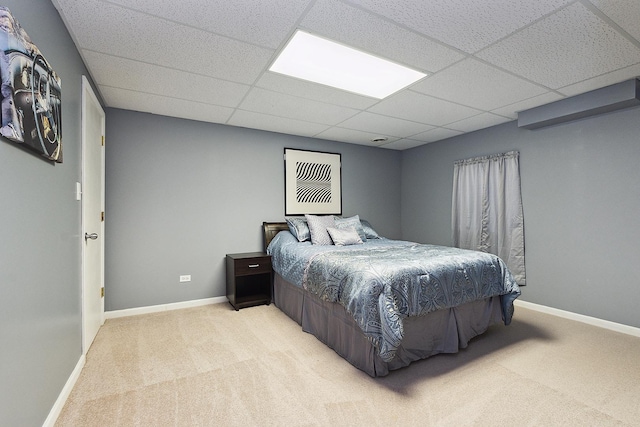 carpeted bedroom with a paneled ceiling