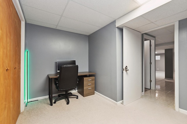 office area with a paneled ceiling