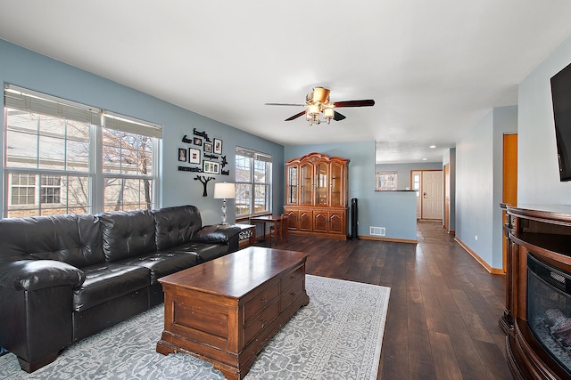 living room with ceiling fan and dark hardwood / wood-style floors