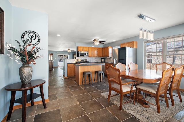 dining area with ceiling fan with notable chandelier