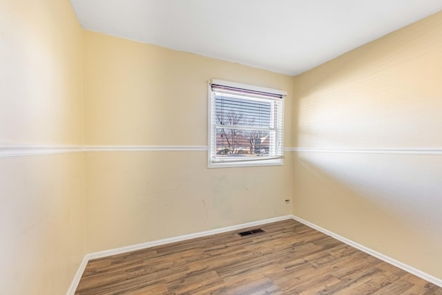 empty room featuring wood-type flooring