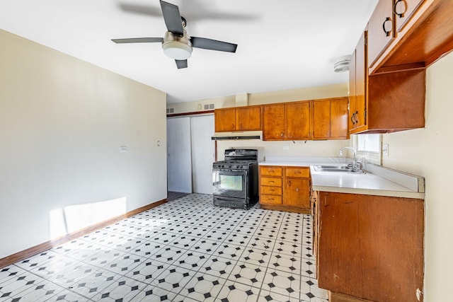 kitchen featuring ceiling fan, sink, and black range with gas cooktop